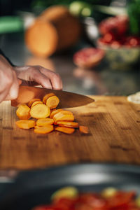 Close-up of chef preparing food on cutting board at restaurant