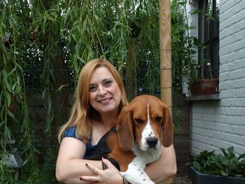 Portrait of young woman with dog