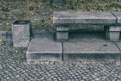 View of stone bench on footpath