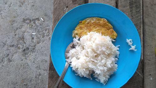 Directly above shot of rice and fried egg in plate on table