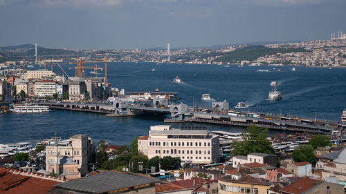 High angle view of buildings by sea against sky
