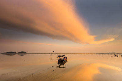 Scenic view of sea against orange sky