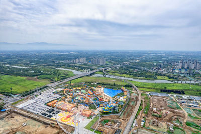 High angle view of buildings against cloudy sky