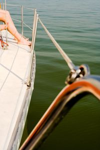Close-up of hand on boat sailing in sea
