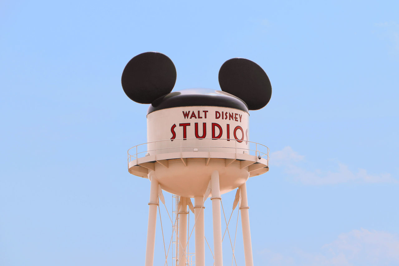 communication, low angle view, text, blue, day, clear sky, outdoors, sky, no people, water tower - storage tank