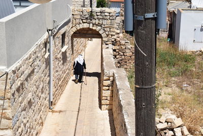 Rear view of woman walking on the western wall in jerusalem 