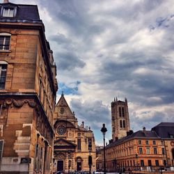 Low angle view of building against cloudy sky