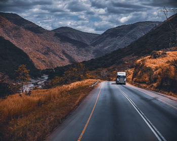 Road amidst mountains against sky