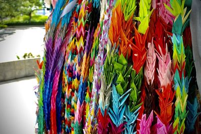 Close-up of multi colored flags hanging for sale