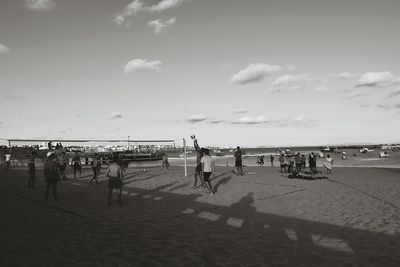 People on beach against sky