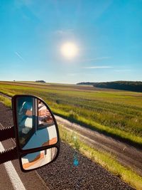 Scenic view of field seen through car windshield