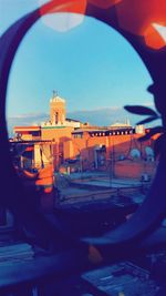 Buildings against clear sky seen through glass window