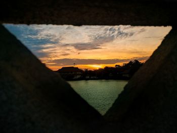 Scenic view of river against sky during sunset