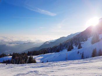 Scenic view of snow mountains against blue sky