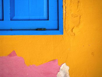 Close-up of yellow wall with closed door