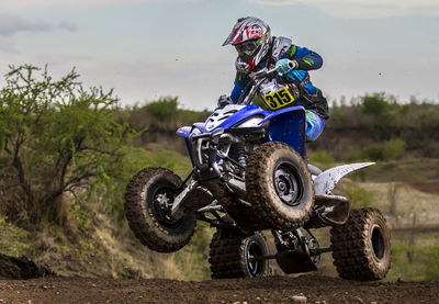 Man riding motorcycle on sand