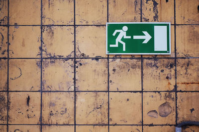 Full frame shot of arrow sign on wall