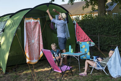 Father with children in front of tent