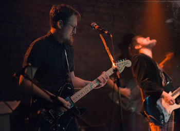 Person playing guitar in music concert