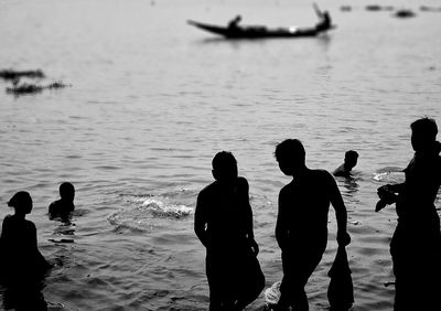 Silhouette people on beach