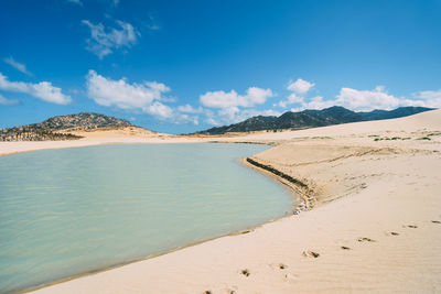 Scenic view of beach against blue sky