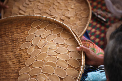 High angle view of woman holding wicker basket