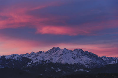 Scenic view of snowcapped mountains against sky during sunset