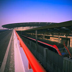 Train on bridge against sky in city