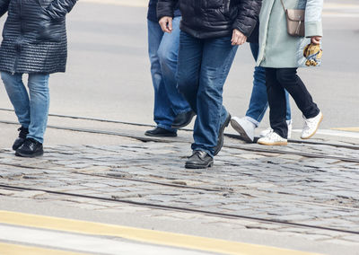 Low section of people standing on street