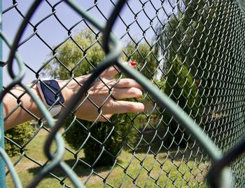 Man seen through chainlink fence