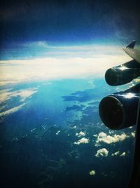 Cropped image of airplane wing over landscape