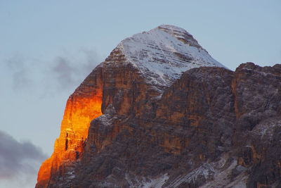 Low angle view of rocky mountain against sky