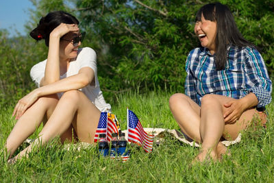 Women with usa flags on lawn, patriotic american national holiday 4th of july independence day