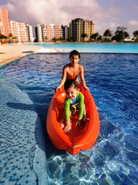 Full length of mother and daughter in swimming pool