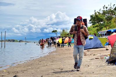 People on beach against sky