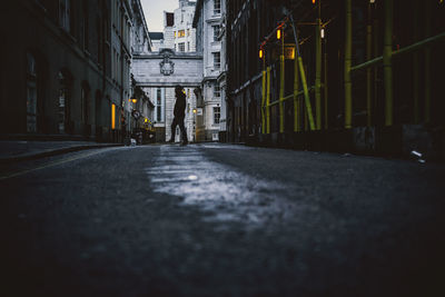 People walking on street amidst buildings in city