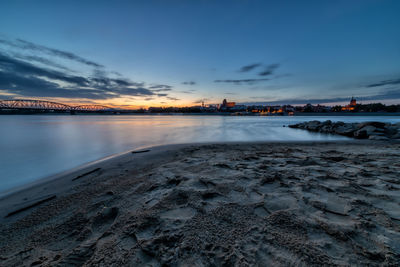 Scenic view of lake against sky during winter