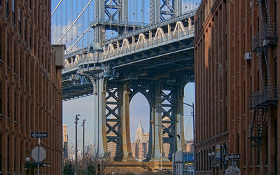 Low angle view of bridge and buildings in city