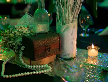 Close-up of illuminated lamp on table in temple