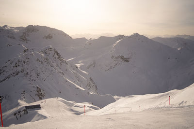 Scenic view of snowcapped mountains against sky during sunset