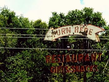 Text on plants against sky