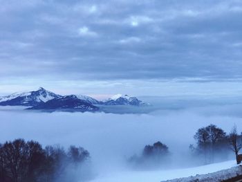 Scenic view of snow covered mountains against sky