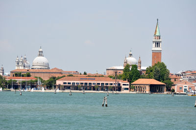View of building by canal against sky