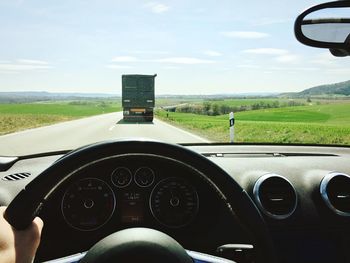 Cropped image of car on country road