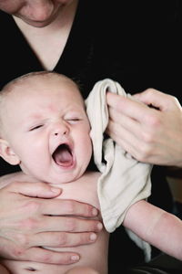 Close-up of father holding baby hand