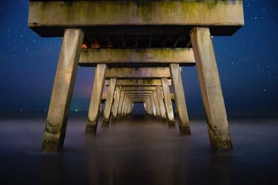 Below view of jetty on shore at beach