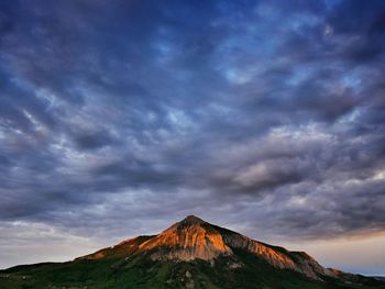 Scenic view of mountain against cloudy sky