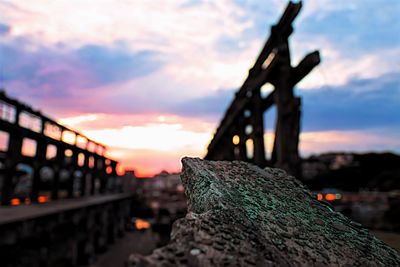 Close-up of metal bridge against sky during sunset