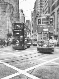 Cars on street in city against sky