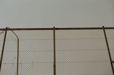 Close-up of fence against sky